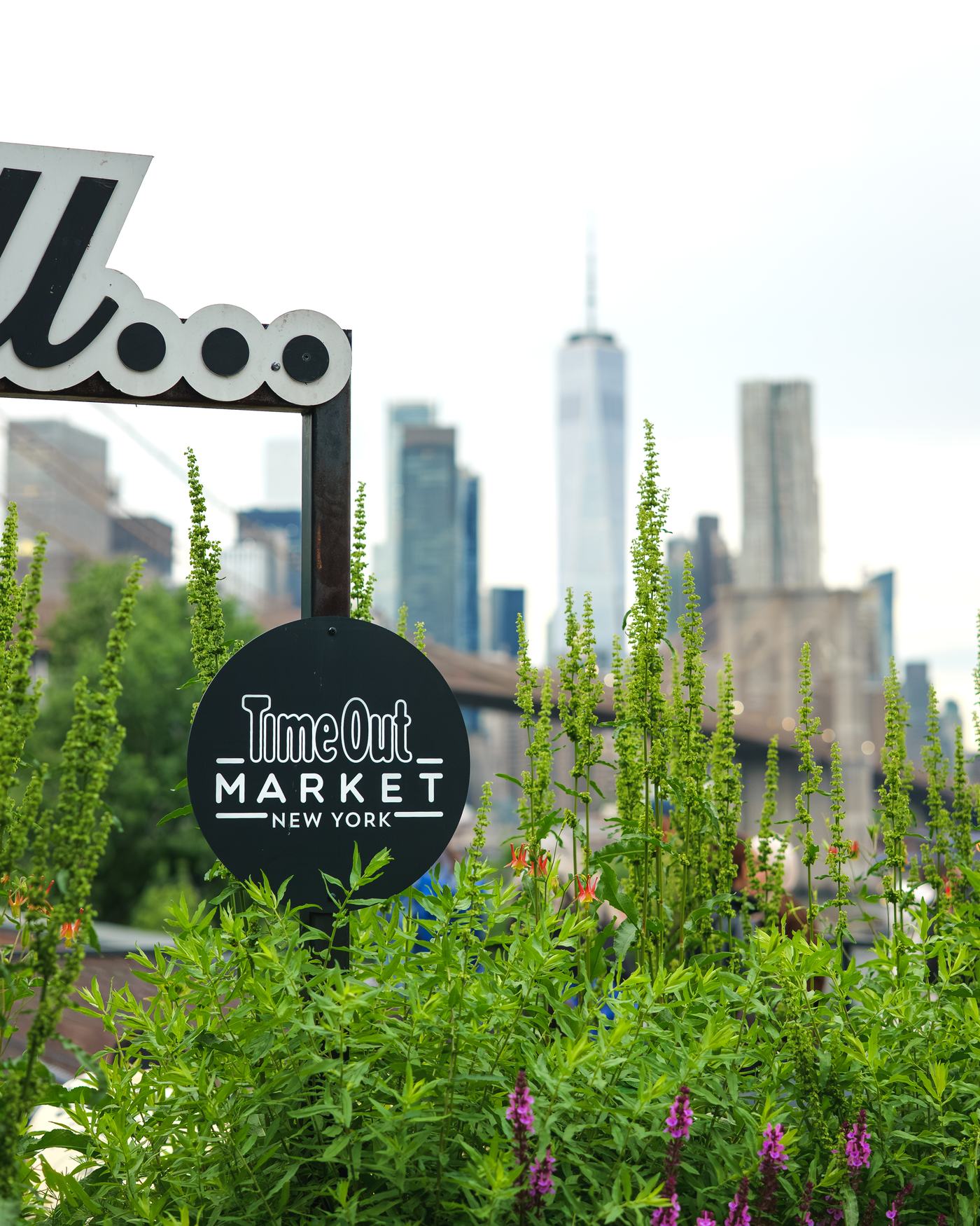Time Out Market New York sign against the Manhattan skyline