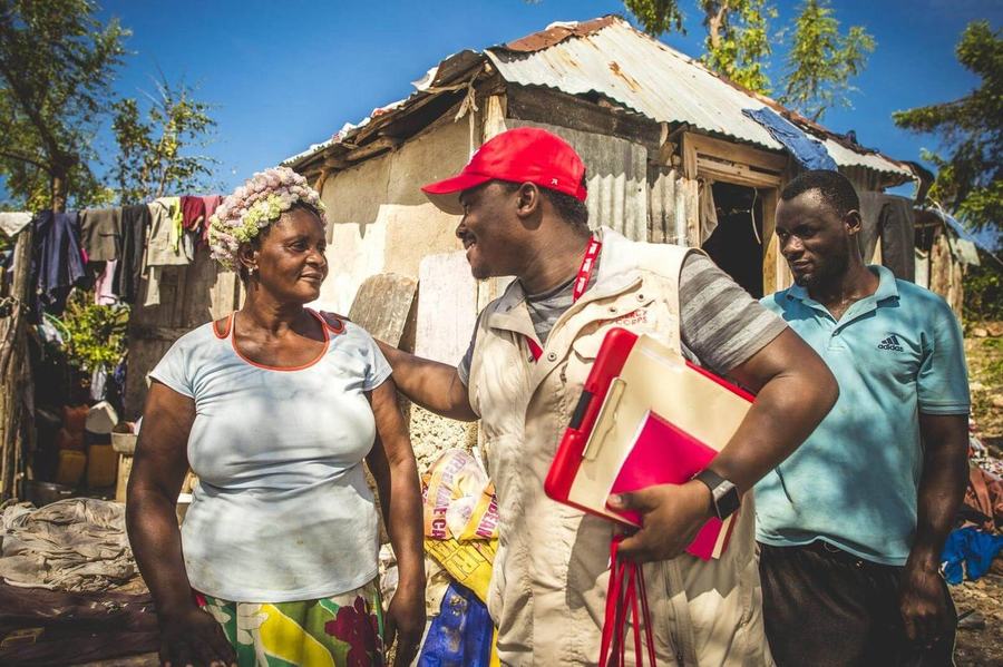 Mercy Corps field team meeting with community members at a home visit