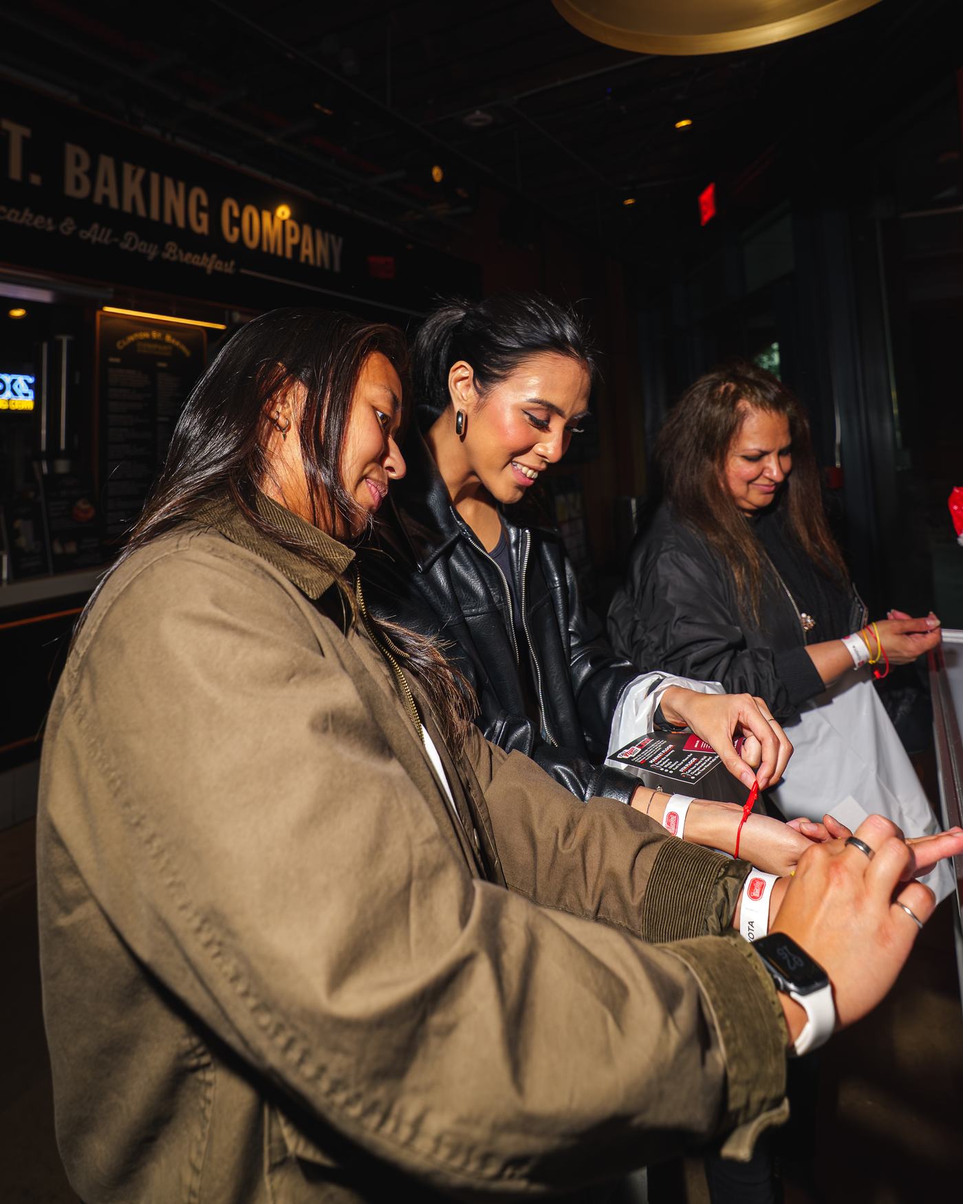 Guests fist-bumping in event wristbands