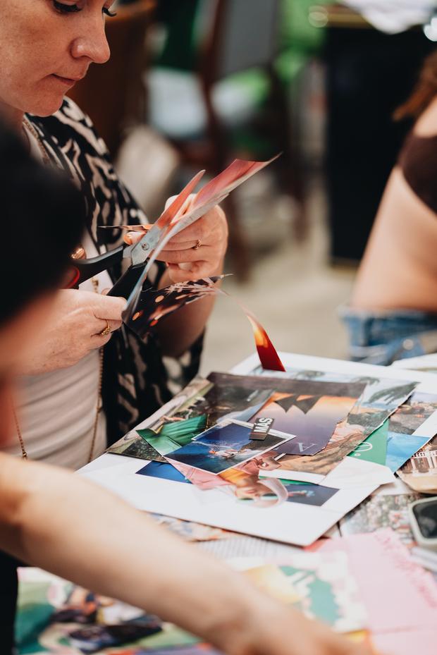 Guest cutting images for a vision board at Entre Manos