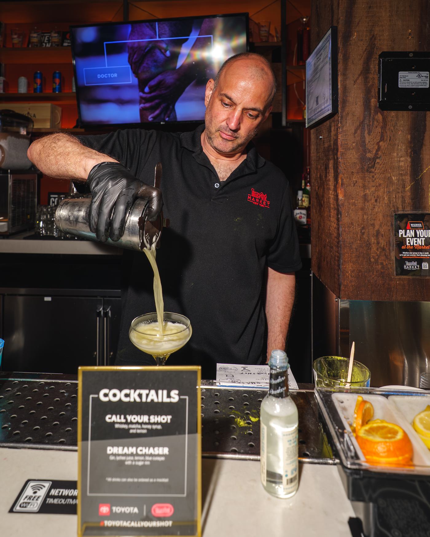 Bartender pouring a custom cocktail from the Call Your Shot menu