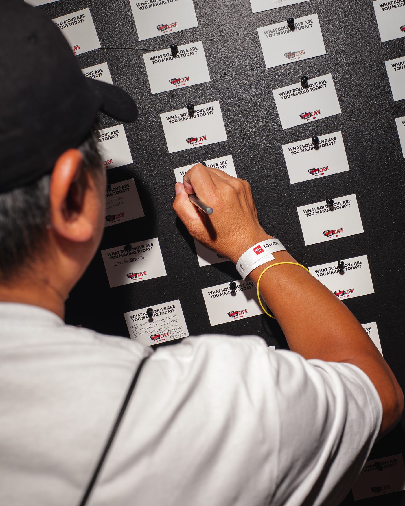 Guest signing the activation wall of cards